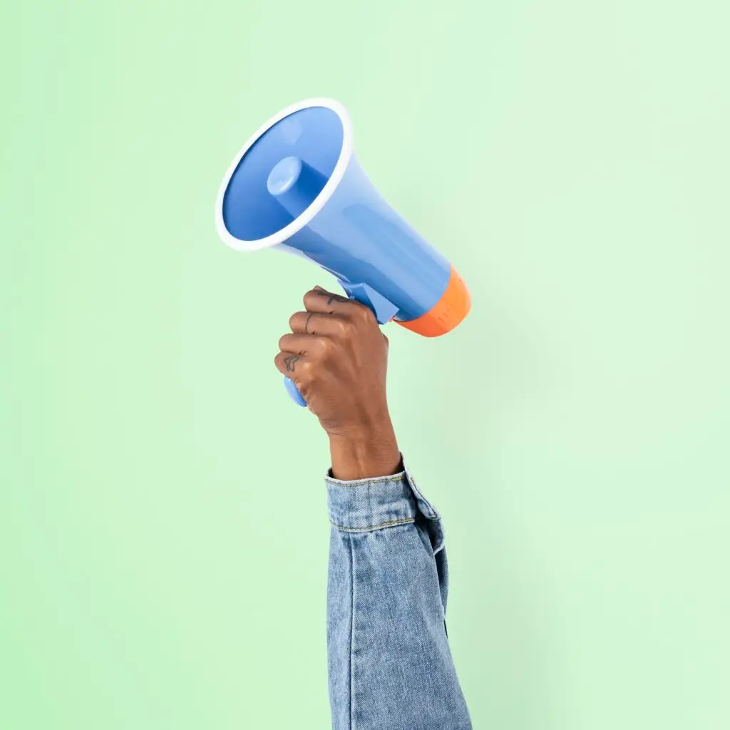 Hand holding megaphone marketing announcement campaign